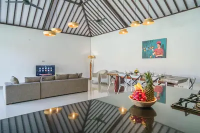 a living room with a couch and a bowl of fruit on a table at Villa Kusuma 2 Seminyak in Seminyak