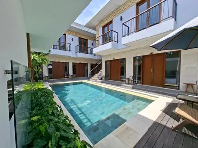a swimming pool in the middle of a building at Mahesa Seminyak in Seminyak