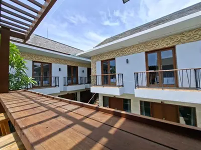 a view of the outside of a house with a wooden deck at Mahesa Seminyak in Seminyak