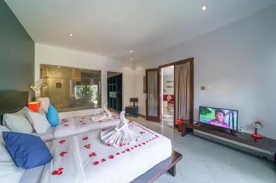 a living room with a bed and a tv at Villa Sun Seminyak in Seminyak