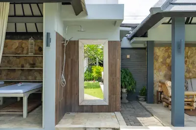 a bathroom with a shower with a glass door at Luxury Aliya Villa by Betterplace in Sanur