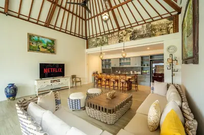 a living room with a couch and a table at Luxury Aliya Villa by Betterplace in Sanur