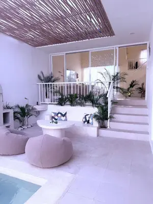 a room with a pool and some plants at Luxury Villa Grand Sanur in Sanur