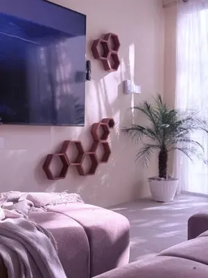 a bedroom with a tv and a potted plant at Luxury Villa Grand Sanur in Sanur