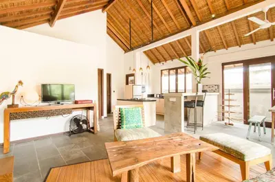 a living room with a couch and a table at Lush 1 BR Private Pool Villa inSeminyak in Kerobokan