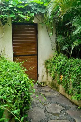 a wooden door on the side of a building at Lush 1 BR Private Pool Villa inSeminyak in Kerobokan
