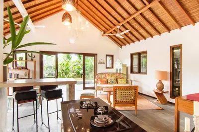 a living room with a table and chairs at Lush 1 BR Private Pool Villa inSeminyak in Kerobokan