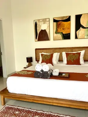 a bedroom with a bed with a tray of towels at 3BR Luxury Retreat Umalas with Pool - Villa Theo in Canggu