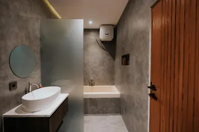 a bathroom with a sink and a toilet and a tub at Casa Nika Suites Seminyak in Seminyak