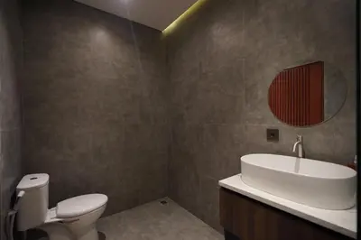 a bathroom with a toilet and a sink and a mirror at Casa Nika Suites Seminyak in Seminyak