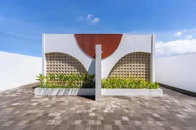 a building on top of a roof with plants at Villa Bellora by Pertama Management in Seminyak