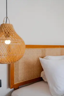a lamp and a pillow on a bed at Villa Bellora by Pertama Management in Seminyak