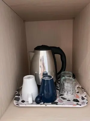 a tea kettle and other items on a shelf at Summerville Homes in Canggu