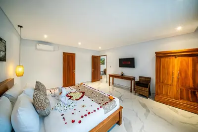 a large bedroom with a bed and a desk at Villa Lotus Seminyak in Seminyak