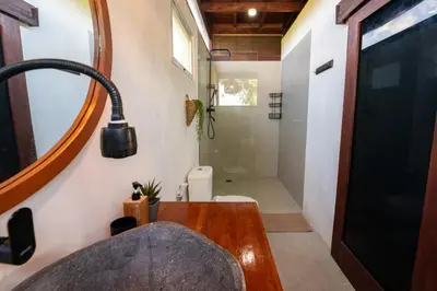 a bathroom with a sink and a toilet and a mirror at New Villa Uluwatu 1BR 1K with Private pool in Jimbaran