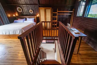 a bedroom with a bed and a staircase in a room at New Villa Uluwatu 1BR 1K with Private pool in Jimbaran