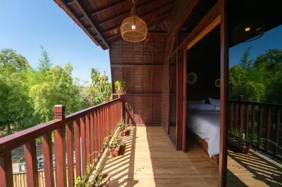 a balcony of a house with a bed on it at New Villa Uluwatu 1BR 1K with Private pool in Jimbaran
