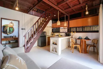 an open kitchen and living room with a staircase at New Villa Uluwatu 1BR 1K with Private pool in Jimbaran