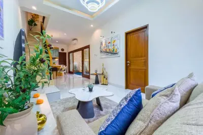 a living room with a couch and a table at Ghayda Entire 3 BR Private Pool Villa in Seminyak