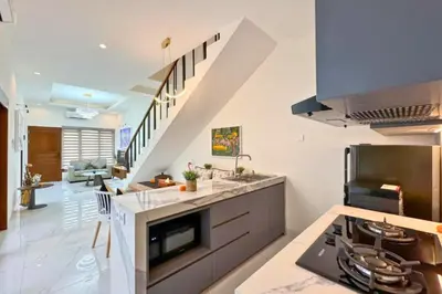 a kitchen with a stove and a counter top at Ghayda Entire 3 BR Private Pool Villa in Seminyak