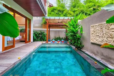 a swimming pool in the backyard of a house at Belisaria Comfortable 3 BR Private Pool Villa in Sanur