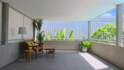 a balcony with chairs and a table on a balcony at Naiika villa in Seminyak