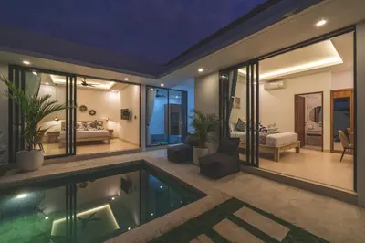 a house with a swimming pool and a bedroom at Villa Kusuma 3 Seminyak in Badung