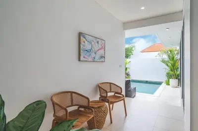 a living room with chairs and a pool at Villa Kusuma 3 Seminyak in Badung