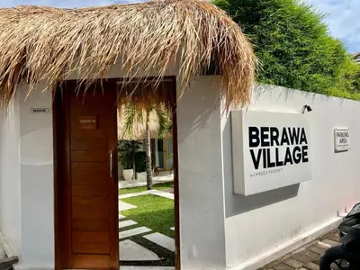 a sign on the side of a white building with a strawilion villa at 1BR Tropical Villa With Pool - Canggu - Berawa in Canggu