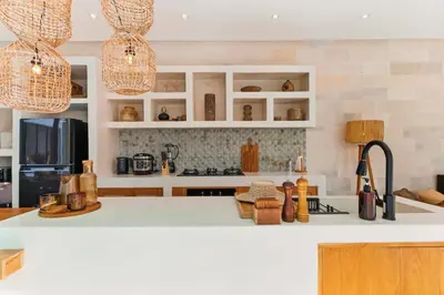 a kitchen with white cabinets and a white counter top at Luxury Villa in Berawa Beach 3BR - Canggu in Canggu