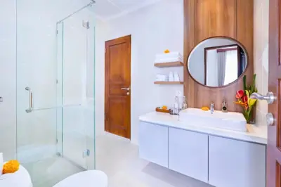 a bathroom with a sink and a shower and a mirror at Zelene Elegant 3 BR Private Pool Villa in Seminyak