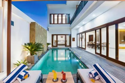 a swimming pool in a villa with a house at Zelene Elegant 3 BR Private Pool Villa in Seminyak