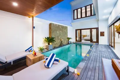 a villa with a swimming pool and a house at Zelene Elegant 3 BR Private Pool Villa in Seminyak