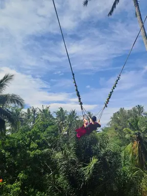 a person swinging on a rope swing at Bali Swing with Buggy adventure and white water Rafting in Pesanggaran