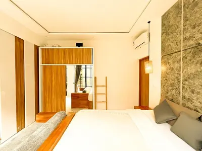 a bedroom with a bed and a large window at Villa Mikhail Seminyak in Seminyak