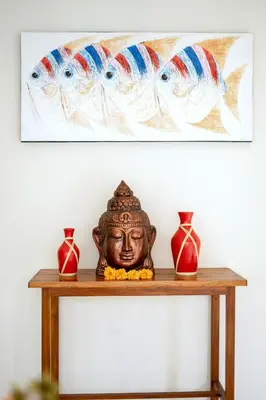a statue on a table with three vases on it at Villa Alamanda, central location and close to restaurants in Seminyak