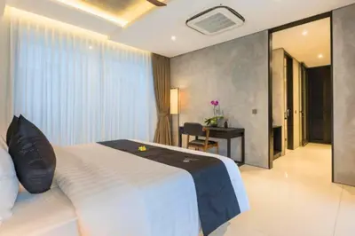 a bedroom with a bed and a desk in a room at Tanaya Luxury 4 BR Private Pool Villa in Canggu