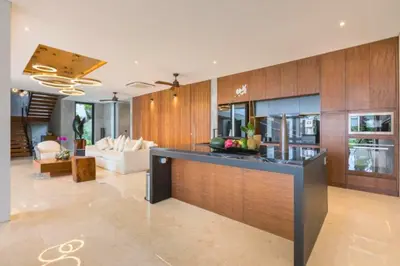 a kitchen and living room with a bar in a house at Tanaya Luxury 4 BR Private Pool Villa in Canggu