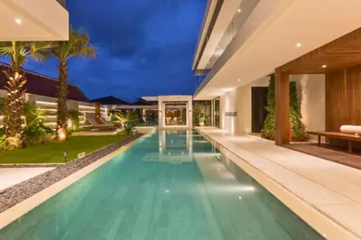 an infinity pool in the backyard of a house at Tanaya Luxury 4 BR Private Pool Villa in Canggu