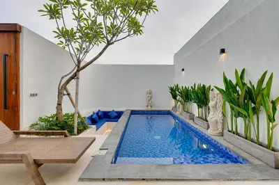 a swimming pool in a house with trees and plants at Modern 2BR Villa Reisi Malindra M12 in Denpasar in Kerobokan