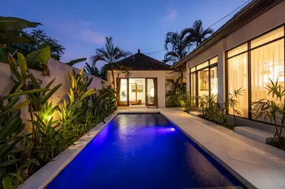 a swimming pool in front of a house at Ola - Private Villa - Umalas in Kerobokan