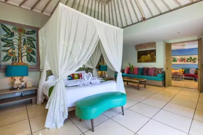 a bedroom with a large bed with a canopy at Kevia Peaceful 3 BR Private Pool Villa in Seminyak