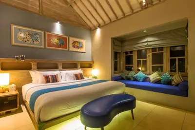 a bedroom with a large bed and a window at Kevia Peaceful 3 BR Private Pool Villa in Seminyak