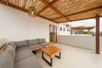 a living room with a couch and a table at Modern 1BR Villa with Private Pool in Kerobokan