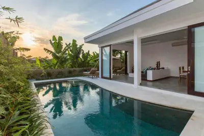 a swimming pool in front of a villa at Orvala Comfortable 2 BR Private Pool Villa in Seminyak