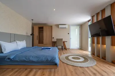 a bedroom with a bed and a flat screen tv at Springleaf Villa in Nusa Dua
