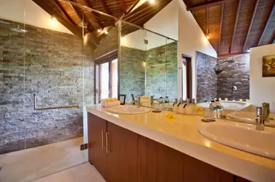 a bathroom with two sinks and a large mirror at Philana Cozy 3 BR Private Pool Villa in Seminyak