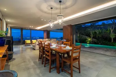 a dining room with a table and chairs at Santos Cliff View Jimbaran in Jimbaran