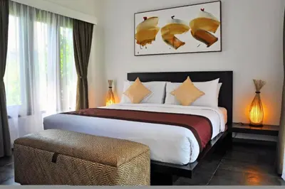 a bedroom with a large bed and a window at Fidela Comfortable 3 BR Private Pool Villa in Seminyak