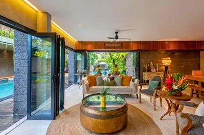 a living room with a couch and a table at Kalysta Spacious 4 BR Private Pool Villa in Canggu